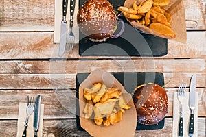 Veggie burgers in a bun with sesame seeds . Delicious fast food for vegans on a wooden background.