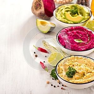Veggie hummus, different dips, vegan snack, beetroot and avocado hummus, vegetarian eating, square image