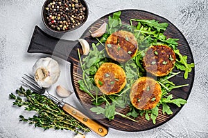 Veggie patty cutlet with lentils, vegetables and arugula. White background. Top view