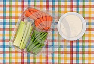 Veggies in a container with ranch dressing to the side