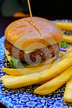 Veggy burger served with fried potato and hot chuthey sauce