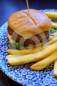 Veggy burger served with fried potato and hot chuthey sauce