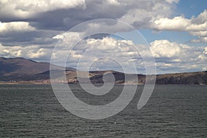 Vegoritida lake under cloudy sky with cliffs in the background