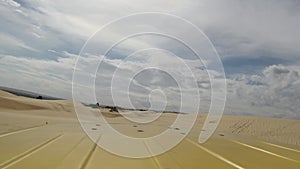 Vehicle dune bashing on the sand dunes of the Mui Ne town, Vietnam. Extreme adventure pickup truc moves on the desert