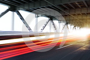 Vehicle light trails on a modern bridge.