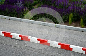 Vehicle protection entry barrier, lane-to-lane crossing road markings deceleration element in traffic red white plastic fastened
