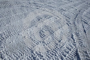 Vehicle tracks crossing the snowy terrain