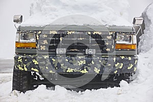 Vehicle trapped under the snow. Cold winter time.