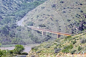 Vehicle is visible on bridge through spray of the Gariep Dam
