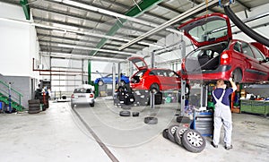 Vehicles in a car repair shop on the lifting platform for repair