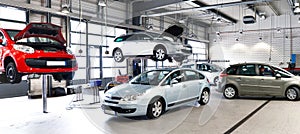 vehicles in a car repair shop for the repair with lifting platform photo
