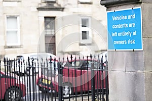 Vehicles and contents left entirely at owners risk and liability sign and cars in background