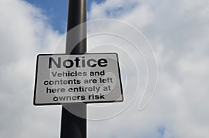 Vehicles and contents left at owners risk sign.