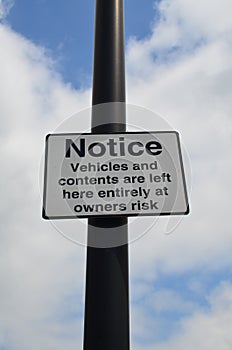 Vehicles and contents left at owners risk sign.