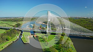 Vehicles drive on sunny massive Redzinski Bridge in Poland