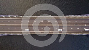 Vehicles Driving Across a Bridge Crossing a River