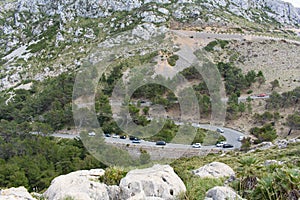 Vehicles driving on a winding serpentine road at Mirador Es Colomer in Cap de Formentor, Mallorca, Spain