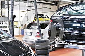vehicles in a garage - repair and inspection of cars on a lifting platform