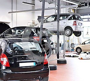 vehicles in a garage - repair and inspection of cars on a lifting platform