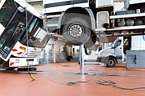 vehicles in a garage - repair and inspection of cars on a lifting platform