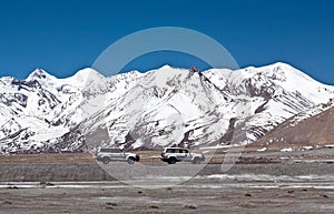 Vehicles goes on the mountain way in Ngari prefecture, Western Tibet