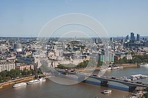 Vehicles moving on waterloo bridge over Thames river by city in London