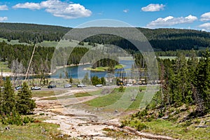 Vehicles parked along the side of the road near the Mud Volcano area of Yellowstone National Park, during the busy summer tourism