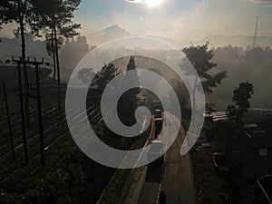 Vehicles passing by in the Lembang area, West Java, Indonesia on a foggy morning