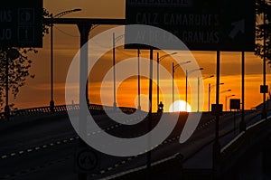 Vehicular bridge silhouette during a sunrise