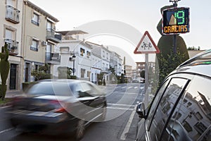 Vehicule crossing close to radar speed sign pole