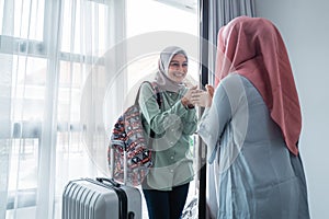 Veiled women greeting salam when meeting her friend