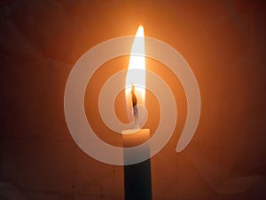 Veiw of one candle light blurred background for design stock photo, candle flame burning