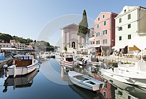 VELI LOSINJ, CROATIA, AUGUST 31, 2011: View of the historic harbor of Veli LoÃÂ¡inj with boats, St. Antun Opat Pustinjak church