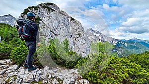 Velika Baba  - A hiking man with helmet on a hiking trail in Kamnik Savinja Alps in Carinthia, Austria, Slovenia