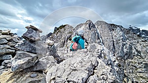 Velika Baba  - A hiking woman with helmet on a hiking trail in Kamnik Savinja Alps in Carinthia, Austria, Slovenia