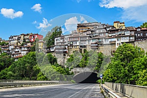 Veliko Tarnovo Bulgaria - houses on the mountain and tunnel underneath - blue sky