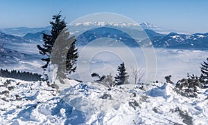 Velka luka hill in Mala Fatra mountains with Tatras mountains in Slovakia during winter