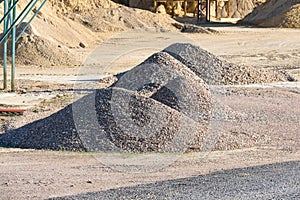 Velt conveyors and a piles of rubble in gravel quarry, crushed sand in different sizes