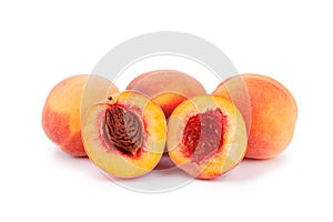 Peaches whole and cutted in halves on a white background isolated close up