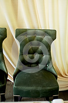 Velvet green chair with a carriage screed.Palace interior.