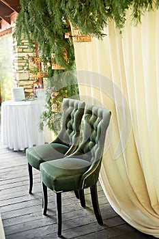 Velvet green chair with a carriage screed.Palace interior.