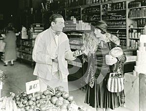 Vendor bargaining with woman at market photo