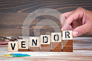 Vendor concept. Wooden letters on the office desk, informative and communication background photo