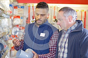 Vendor in hardware shop with client