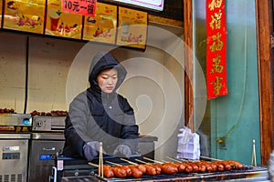 A vendor selling food on walking street