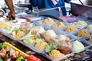 Vendor selling nasi tomato in street bazaar stall for iftar