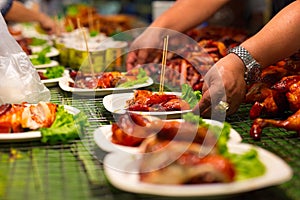 Vendor Serving Meat In Plates At Thai Street Food