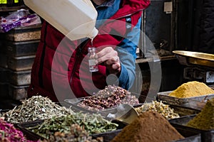 Vendor at spice , herb, perfume and oil store in souq, Damascus, Syria