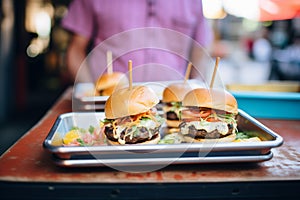 vendors freshlymade burgers on serving tray