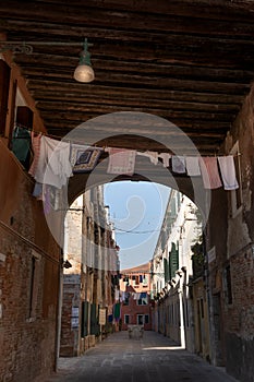 Venetian architecture: traditional alley, laundry being dried on a clothes line. Venice, Italy